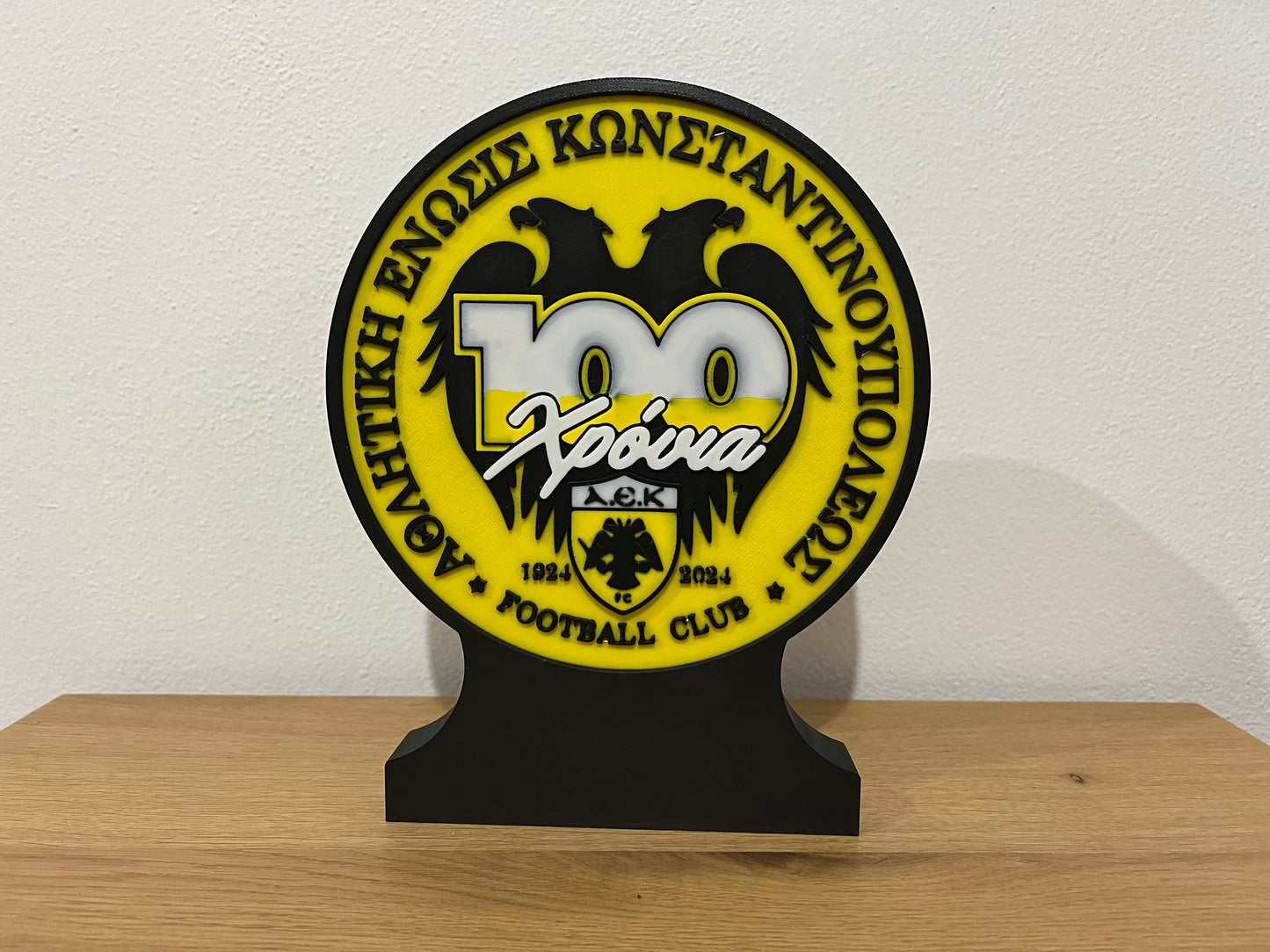 The AEK 100 Anniversary Logo Stand